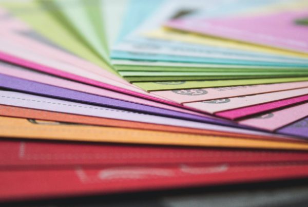 a close up of many different colored papers