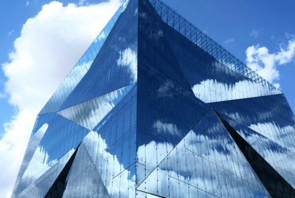 blue and white glass building under blue sky during daytime